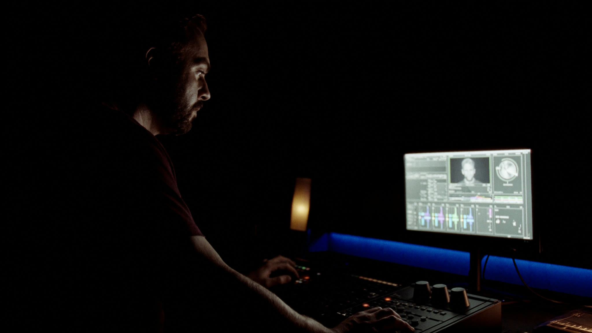 A colorist at a grading panel